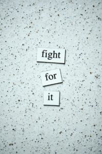 Black Text on White and Black Wall. Text reads 'fight for it'