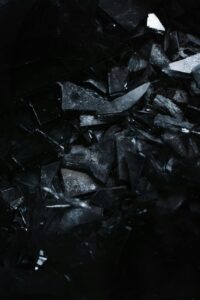 Fragments of Broken Glass on a Black Surface